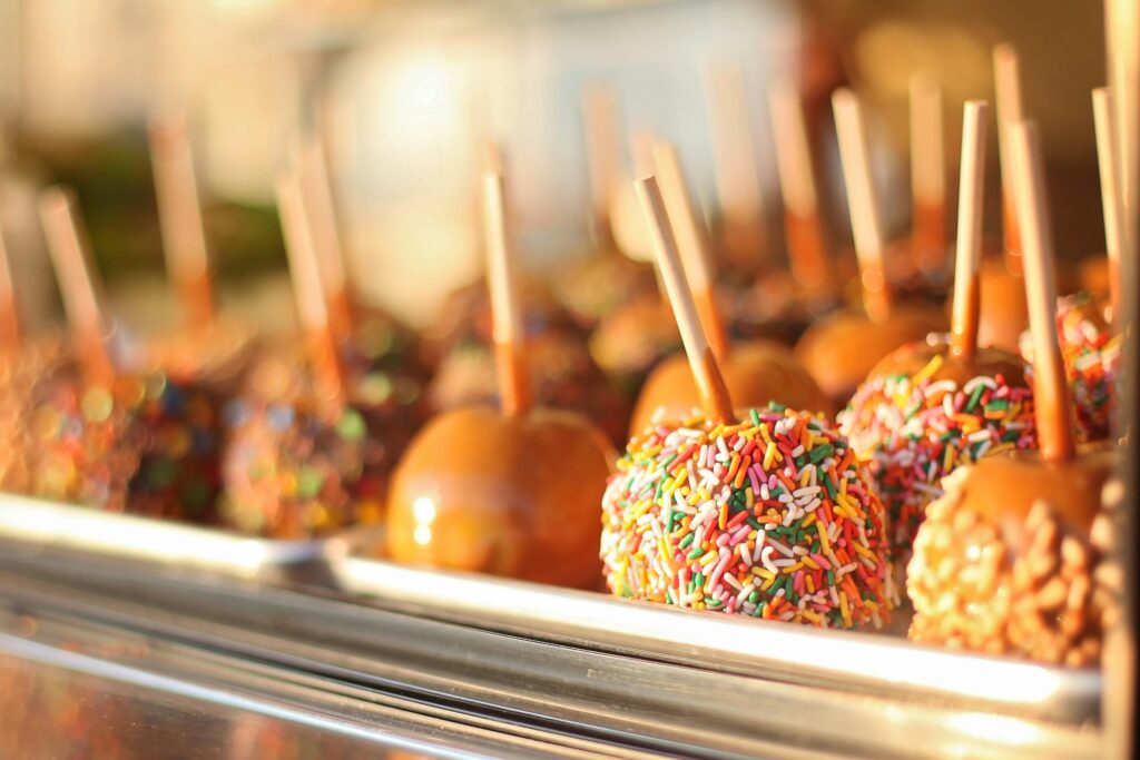a tray full of caramel apples