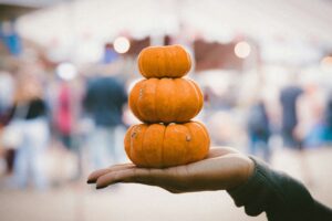 three pile of pumpkins on a person's palm